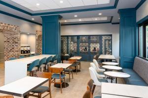 un restaurant avec des murs bleus, des tables et des chaises dans l'établissement Hampton Inn Savannah Historic District, à Savannah
