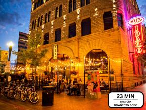 a group of people sitting at tables outside of a building at Play Relax Ping Pong, Foosball, Arcades, Park in Meridian