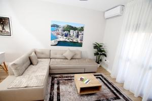 a living room with a couch and a table at The Met Apartments in Durrës