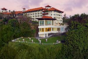 a building on a hill with a lawn in front of it at Hilton Bali Resort in Nusa Dua