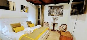 a bedroom with a bed and two chairs in it at Piazza di Spagna Heart Of Rome Best LocatioN in Rome