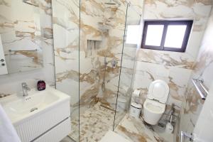 a bathroom with a toilet and a sink at The Met Apartments in Durrës +34 photos