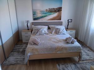 a bedroom with a large bed with two night stands at Apartments by the sea Postira, Brac - 12291 in Postira