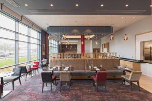 a dining room with a large table and chairs at Hilton Garden Inn Birmingham Airport Uk in Bickenhill