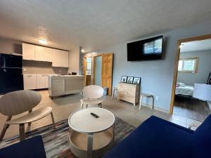 a living room with a table and chairs and a kitchen at North Coast Place in Marquette