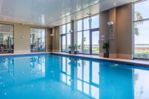 a swimming pool in a building with windows at Radisson Blu Waterfront Hotel, Jersey in Saint Helier Jersey