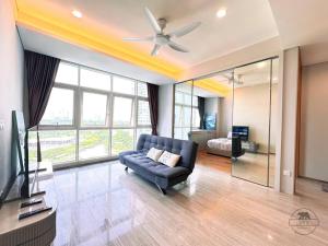 a living room with a couch and a ceiling fan at Pinetree Marina Resort by WP HOMESTAY in Johor Bahru