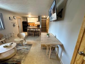 a living room with a table and a kitchen at North Coast Place in Marquette