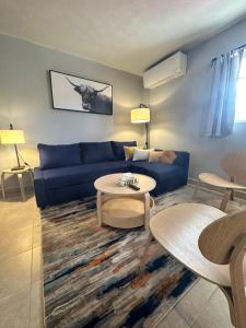 a living room with a blue couch and a table at North Coast Place in Marquette