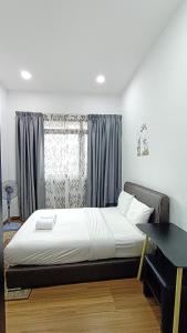a bedroom with a large bed with a window at Taragon Condominiums- KL in Kuala Lumpur