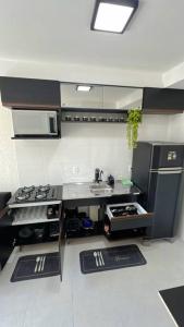 a kitchen with a stove and a sink in it at Ponte Laguna, Parque Burle Max in Sao Paulo