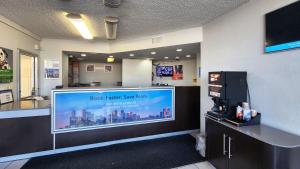 a waiting room with a large flat screen tv at Studio 6 Houston TX Medical Center NRG Stadium in Houston