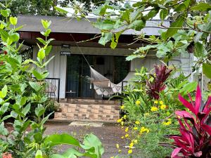 a porch of a house with a hammock on it at Almendros Eco-Villas in Fortuna