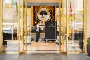 a man standing inside of a glass door at Waldorf Astoria Doha West Bay in Doha