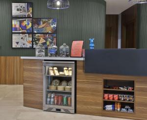 a counter in a room with a shelf with drinks at Hampton By Hilton Sharma - NC1 in Khuraybah