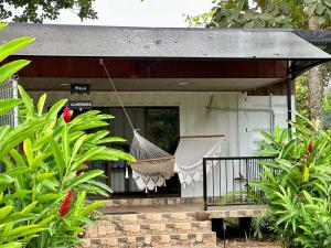 a hammock hanging from a porch of a house at Almendros Eco-Villas in Fortuna