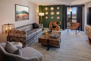 a living room with a couch and a coffee table at Whitney Peak Hotel Reno, Tapestry Collection by Hilton in Reno