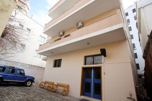 a blue jeep parked in front of a building at The Met Apartments in Durrës