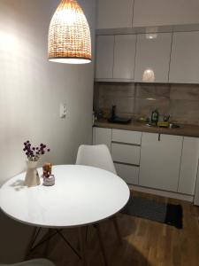 a white table and chairs in a kitchen at Zeka in Kruševac