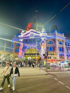 a group of people walking in front of a building at Studio Apartment in Melbourne CBD in Melbourne