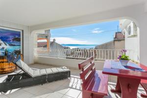 a balcony with a table and chairs and a view at Apartments by the sea Tucepi, Makarska - 22384 in Tučepi