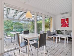 a dining room with a table and chairs at Holiday home Nexø XX in Neksø