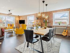 a dining room with a table and chairs at Holiday home Skagen XL in Skagen