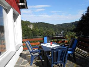 a table and chairs on a balcony with a view at Holiday apartment dream view 2 in Monschau
