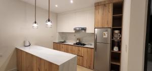 a kitchen with a white counter and a refrigerator at DEPARTAMENTO ESTILO NORDICO in Tarija