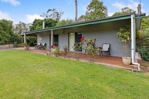a house with a patio and a yard at Clarendon Chalets in Mount Gambier