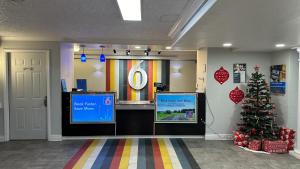 a lobby with a christmas tree and a tv at Motel 6-Beaumont, TX in Beaumont