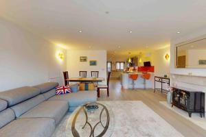 a living room with a couch and a fireplace at Stunning, CastleView, Riverside, Modern Townhouse in Eton