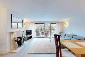 a living room with a couch and a fireplace at Stunning, CastleView, Riverside, Modern Townhouse in Eton