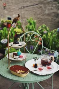 a bird sitting on top of a table with desserts at Simatai No.19 Villa in Miyun