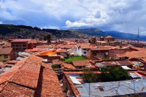 an aerial view of a town with roofs at The Chusay Rooftop in Cusco