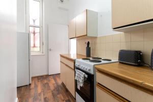 a kitchen with a stove and a counter top at 1 bedroom flat in City Centre in Birmingham