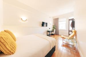 Habitación de hotel con cama y silla en Gaslight Inn - Adults Only en Sídney