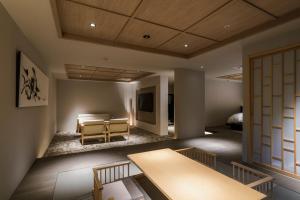 a living room with a table and a couch at Shinzan Kinosaki in Toyooka