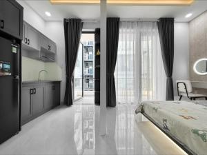 a bedroom with a bed and a kitchen and a table at Newhome luxury apartment in Ho Chi Minh City