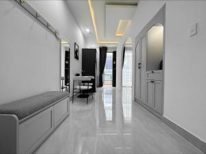 a hallway with a bed and a dining room at Newhome luxury apartment in Ho Chi Minh City