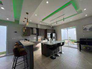 a large kitchen with a island in the middle at Casa sol Perfect for Families in Santa Ana