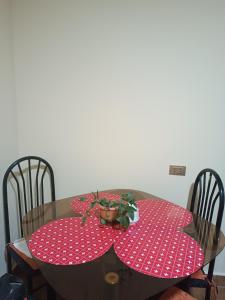 a dining room table with two red polka dot tables at Apartamento cómodo in Potosí