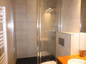 a bathroom with a shower with a toilet and a sink at Résidence Croix De Verdon B - 3 Pièces pour 6 Personnes 82 in Les Allues