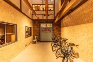 a room with a bunch of bikes parked on the wall at HIDA TAKAYAMA BASE - Traditional Japanese Garage House with Private Sauna in Takayama