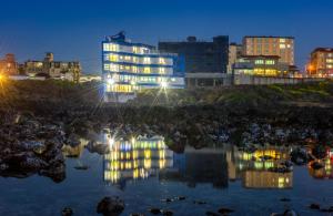 - Vistas nocturnas a una ciudad con luces en el agua en On The Sea Pension en Jeju