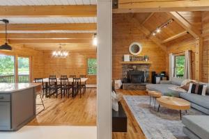 a living room and dining room of a log cabin at Our Pondside Cabin in Westminster