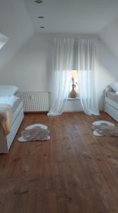 a bedroom with a bed and a window with rugs at Stilvolle Ferienwohnung in Niestetal