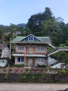 a house with flowers on the front of it at Coral Homestay in Pelling