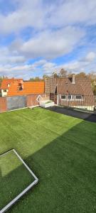 a large grassy field with buildings in the background at Stilvolle Ferienwohnung free parking, Space, WLAN in Niestetal