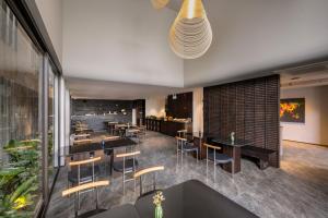 a restaurant with tables and chairs and a bar at Thè HEM Hotel and Apartment in Da Nang